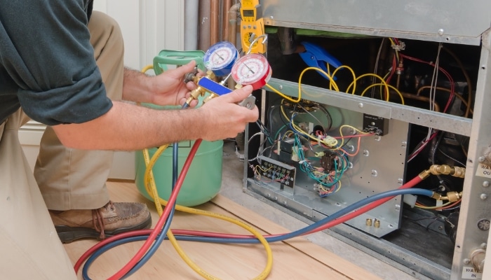 All Out technician working on a heating system in Gilbert, Arizona.